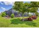 Beautiful landscaping surrounding the screened pool and lanai area in backyard at 13092 Rinella St, Venice, FL 34293