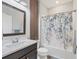 This well-lit bathroom features a framed mirror and a tub with tiled shower at 13092 Rinella St, Venice, FL 34293