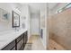 This well-lit bathroom features a double vanity, a linen closet, and a tiled shower at 13092 Rinella St, Venice, FL 34293