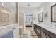 The well-lit bathroom features dual sinks, a walk-in shower, and a bedroom view at 13092 Rinella St, Venice, FL 34293