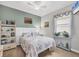 This charming bedroom has ample light, a ceiling fan, and neutral walls at 13092 Rinella St, Venice, FL 34293