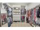 This walk-in closet offers ample storage with adjustable shelves and hanging rods at 13092 Rinella St, Venice, FL 34293