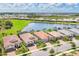 Beautiful homes featuring well-manicured lawns and colorful landscaping near a serene lake at 13092 Rinella St, Venice, FL 34293