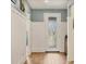Inviting foyer with wood-look tile flooring, decorative wainscoting, and a front door with glass inserts at 13092 Rinella St, Venice, FL 34293