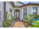 Charming front entrance with colorful flowers and a brick walkway leading to the front door at 13092 Rinella St, Venice, FL 34293
