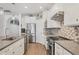 Bright kitchen featuring stainless steel appliances, a mosaic backsplash, and light wood flooring at 13092 Rinella St, Venice, FL 34293