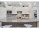 Island view of a bright kitchen with stainless steel appliances, mosaic backsplash, and pendant lighting at 13092 Rinella St, Venice, FL 34293