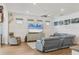Comfortable living room with a ceiling fan, large TV, and plenty of seating for relaxing at 13092 Rinella St, Venice, FL 34293