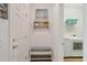 Inviting mudroom with decor, bench, and access to the laundry room featuring modern appliances at 13092 Rinella St, Venice, FL 34293