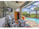 Stylish outdoor space with a sauna, fire table, pool, and lush greenery at 13092 Rinella St, Venice, FL 34293
