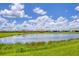 View of community pond with houses in background at 13092 Rinella St, Venice, FL 34293