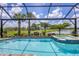 Screened pool and spa with landscaping and view of lake in backyard at 13092 Rinella St, Venice, FL 34293