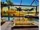 Relaxing pool and spa area with palm trees, set against a picturesque sunset at 13092 Rinella St, Venice, FL 34293