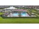 Stunning aerial view of a community pool area with ample seating, a lap pool and lush landscaping at 13092 Rinella St, Venice, FL 34293