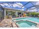 Screened pool and spa with brick paver deck and outdoor kitchen at 13092 Rinella St, Venice, FL 34293