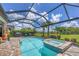 Sparkling pool and spa with a screened enclosure, surrounded by lush landscaping at 13092 Rinella St, Venice, FL 34293