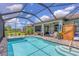Screened pool and lanai with outdoor seating and kitchen area at 13092 Rinella St, Venice, FL 34293