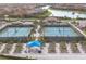 Aerial view of tennis and pickleball courts and community garden, offering active lifestyle amenities at 13092 Rinella St, Venice, FL 34293