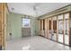Bedroom under renovation with tile flooring, exposed framing, and natural light offering a cozy ambiance at 1350 Holiday Dr, Englewood, FL 34223