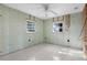 Renovated bedroom featuring tile flooring and two windows, bathed in natural light, offering a bright and airy feel at 1350 Holiday Dr, Englewood, FL 34223