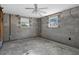 Unfinished bedroom featuring concrete floors, exposed framing, and natural light from windows at 1350 Holiday Dr, Englewood, FL 34223