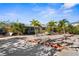 This home's front yard features lush tropical landscaping, including palm trees, for a serene and inviting outdoor space at 1350 Holiday Dr, Englewood, FL 34223