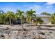 Charming single-story home featuring a metal roof, well-kept landscaping, and a lovely, serene curb appeal at 1350 Holiday Dr, Englewood, FL 34223