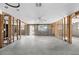 Unfinished living room featuring concrete floors, exposed framing, and natural light from windows at 1350 Holiday Dr, Englewood, FL 34223