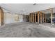 Unfinished living room featuring concrete floors, exposed framing, and walls needing finishing at 1350 Holiday Dr, Englewood, FL 34223