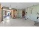 Unfinished living room with tiled floor, walls needing finishing, with an opening to another room at 1350 Holiday Dr, Englewood, FL 34223