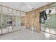 Open-concept living space with tile floors and exposed framing, presenting a blank canvas for renovation ideas at 1350 Holiday Dr, Englewood, FL 34223