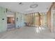 Large open room featuring tile flooring and exposed framing, perfect for customizing to your desired layout and style at 1350 Holiday Dr, Englewood, FL 34223