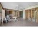 Bright sunroom featuring tile flooring, a ceiling fan, and open walls offering potential for personalized renovation at 1350 Holiday Dr, Englewood, FL 34223