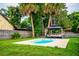 Private backyard with a pool, a gazebo, lush landscaping, and ample space for outdoor activities at 13608 Westshire Dr, Tampa, FL 33618