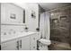 Modern bathroom featuring a sleek vanity, decorative accents, and a beautifully tiled walk-in shower at 13608 Westshire Dr, Tampa, FL 33618