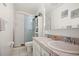 Bright bathroom featuring a double vanity, a glass-enclosed shower, and practical storage solutions at 13608 Westshire Dr, Tampa, FL 33618