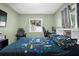 Gaming bedroom featuring colorful comforter, gaming chairs, and large window at 13608 Westshire Dr, Tampa, FL 33618