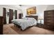 Comfortable bedroom featuring a queen-sized bed, soft lighting, and ample closet space for convenient storage at 13608 Westshire Dr, Tampa, FL 33618