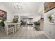 Bright dining room with tile flooring, chandelier, white table, and breakfast bar at 13608 Westshire Dr, Tampa, FL 33618