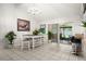 Bright dining room with tile flooring, chandelier, white table, and sliding glass doors at 13608 Westshire Dr, Tampa, FL 33618