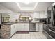 Bright kitchen features white cabinets, stainless steel appliances, and stylish countertop at 13608 Westshire Dr, Tampa, FL 33618