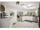 Bright kitchen features white cabinets, stainless steel appliances, and stylish countertop at 13608 Westshire Dr, Tampa, FL 33618
