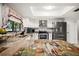 Well-lit kitchen featuring granite countertops, stainless steel appliances, and modern white cabinetry at 13608 Westshire Dr, Tampa, FL 33618
