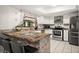 Modern kitchen featuring granite countertops, stainless steel appliances, and a white tile backsplash at 13608 Westshire Dr, Tampa, FL 33618