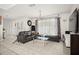 Living room with tile floors, chandelier, contemporary decor, large window, and french doors at 13608 Westshire Dr, Tampa, FL 33618