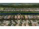 Wide aerial view showcasing the house with lake views and surrounded by a vibrant community at 13841 Campoleone St, Venice, FL 34293