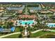 Aerial view of the community clubhouse, pool, bocce ball court, and surrounding community at 13841 Campoleone St, Venice, FL 34293