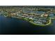 Beautiful aerial view highlighting the community's pools, tennis courts, and lakefront setting at 13841 Campoleone St, Venice, FL 34293