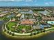 An aerial view of the community clubhouse, pool, bocce ball court, and surrounding lakes and landscaping at 13841 Campoleone St, Venice, FL 34293
