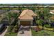 Beautiful aerial shot of a home with well-manicured landscaping and a charming brick driveway at 13841 Campoleone St, Venice, FL 34293